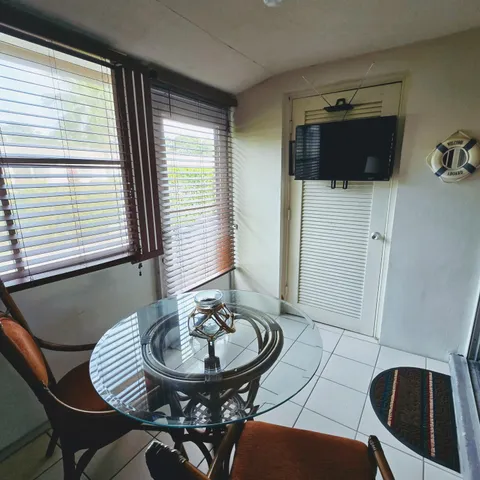 a view of a dining room with furniture and window