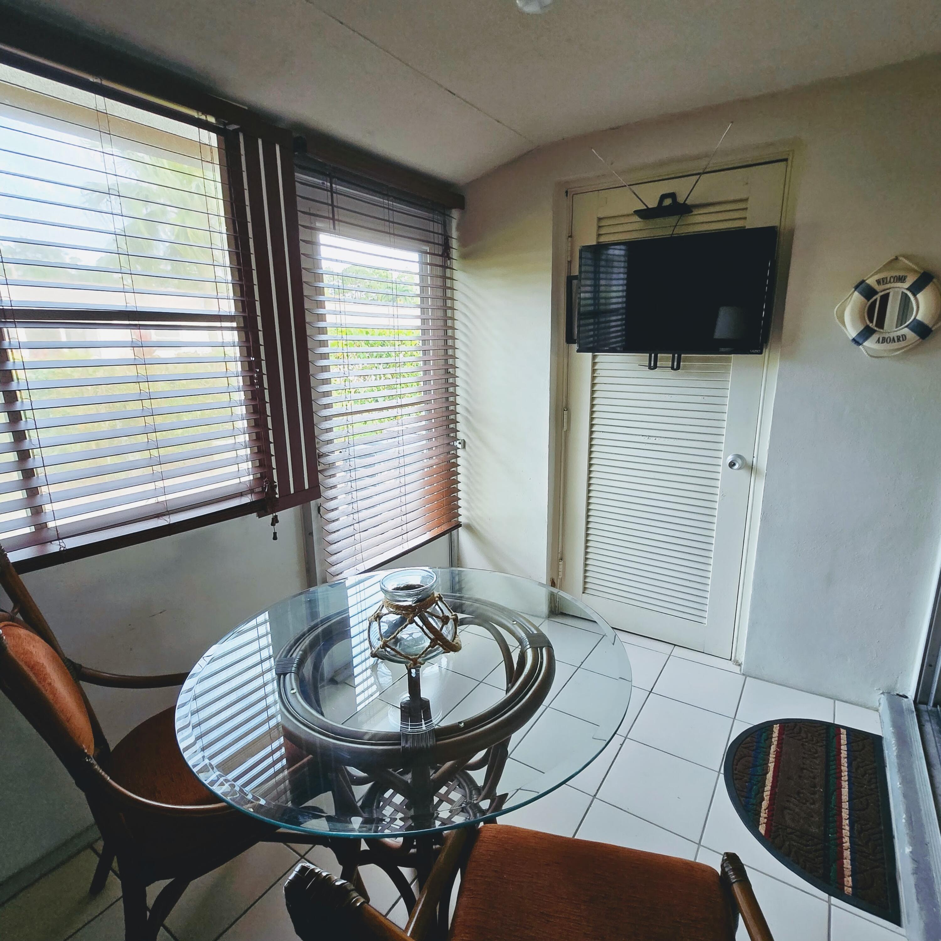 2930 Crosley Drive East, Unit C West Palm Beach, FL 33415 - Photo 11 of 21 a view of a dining room with furniture and window