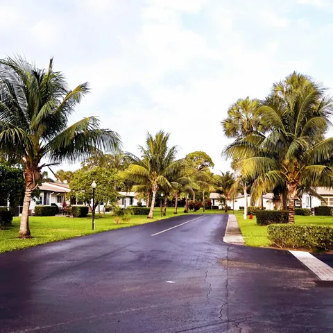 a view of a house with a yard and potted plants