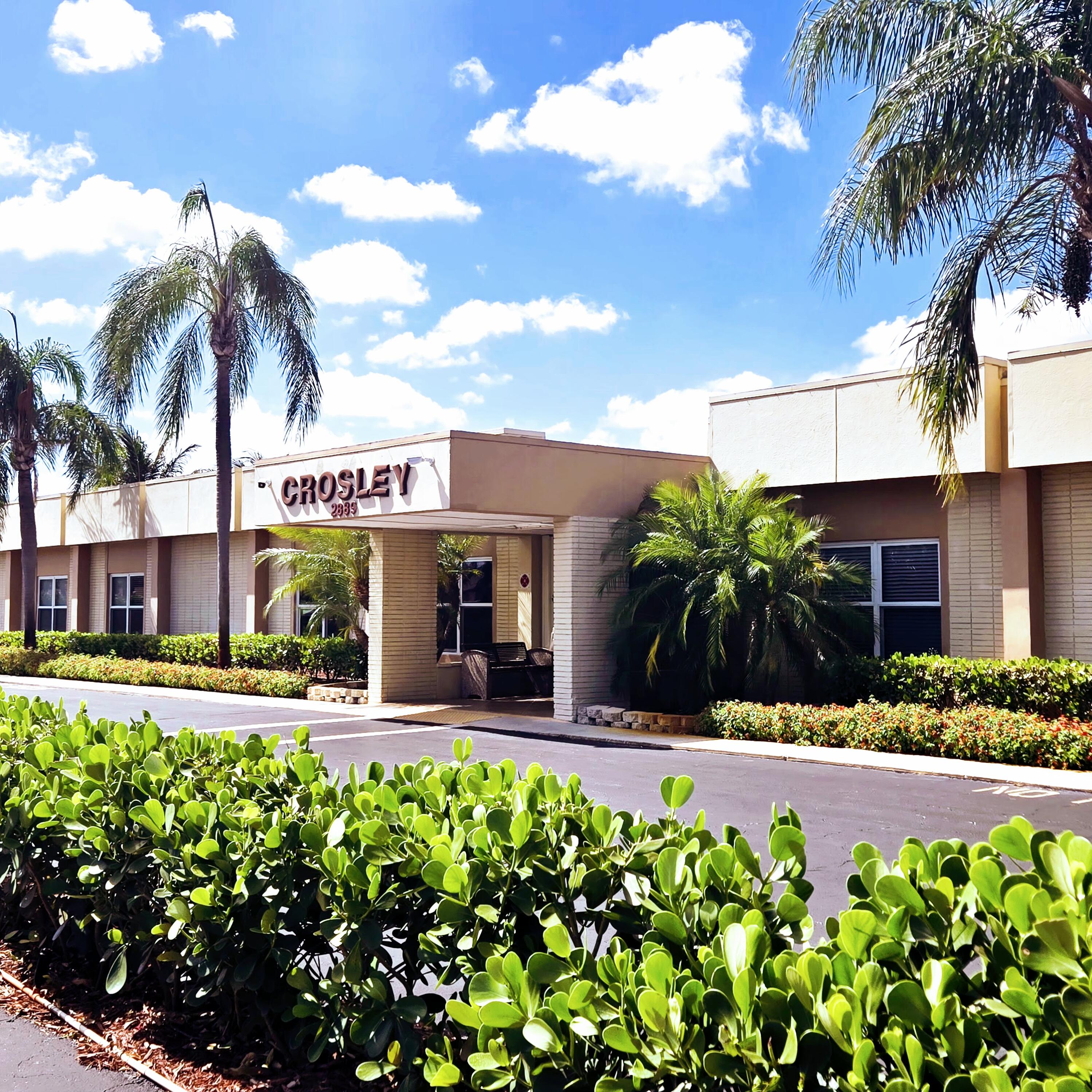 2930 Crosley Drive East, Unit C West Palm Beach, FL 33415 - Photo 18 of 21 a view of a house with a yard and potted plants