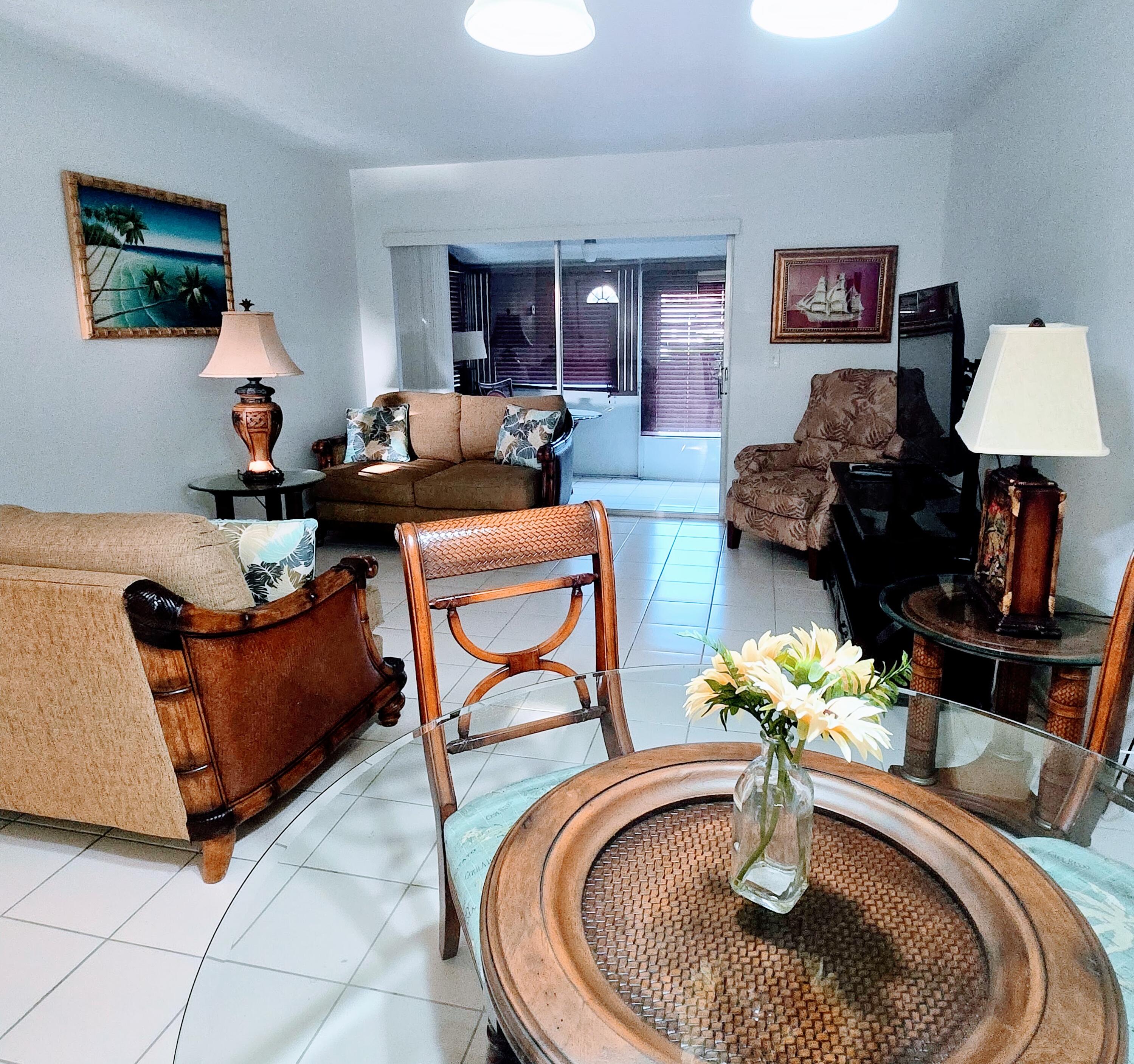 2930 Crosley Drive East, Unit C West Palm Beach, FL 33415 - Photo 2 of 21 a living room with furniture flowerpot and a table