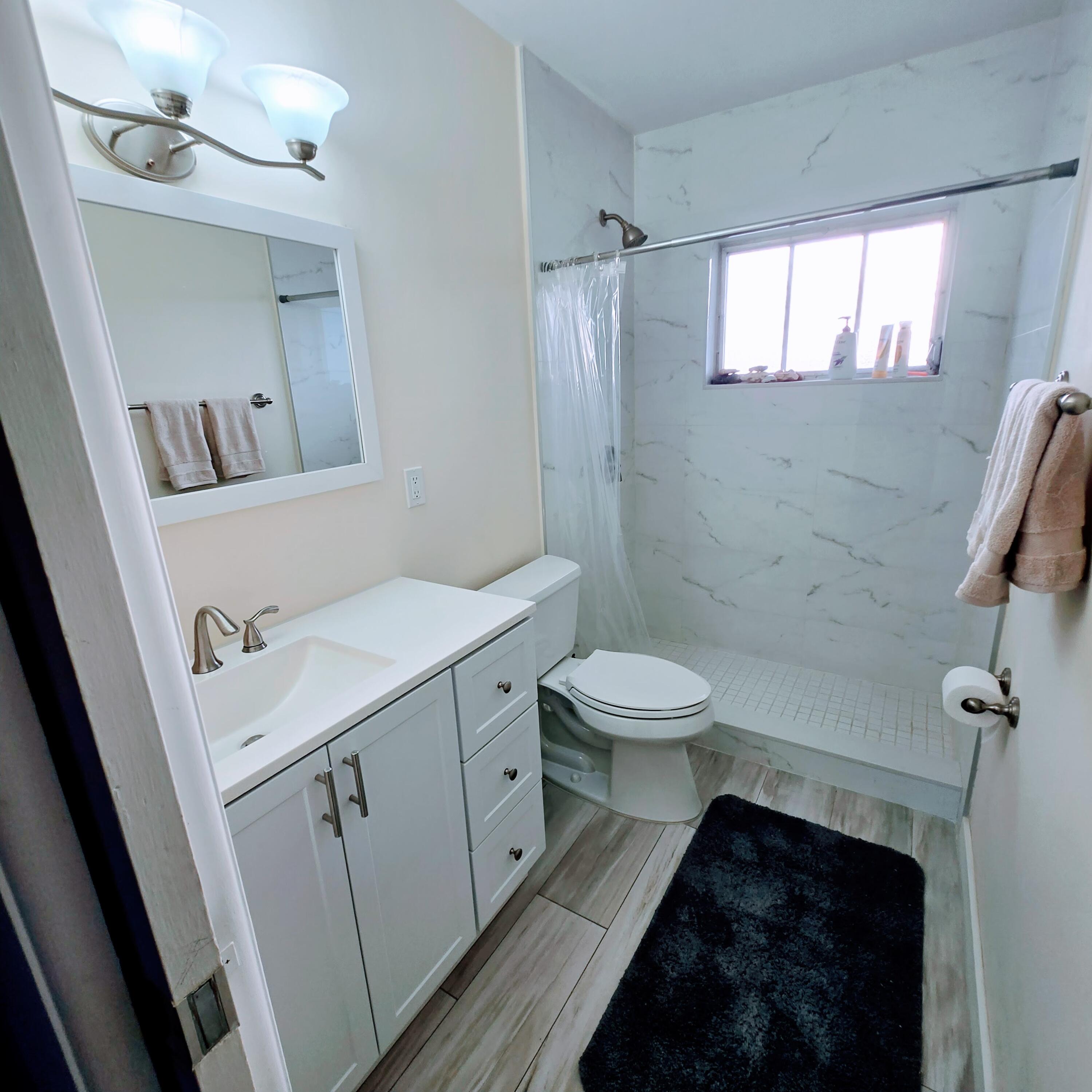 2930 Crosley Drive East, Unit C West Palm Beach, FL 33415 - Photo 8 of 21 a bathroom with a sink and a mirror