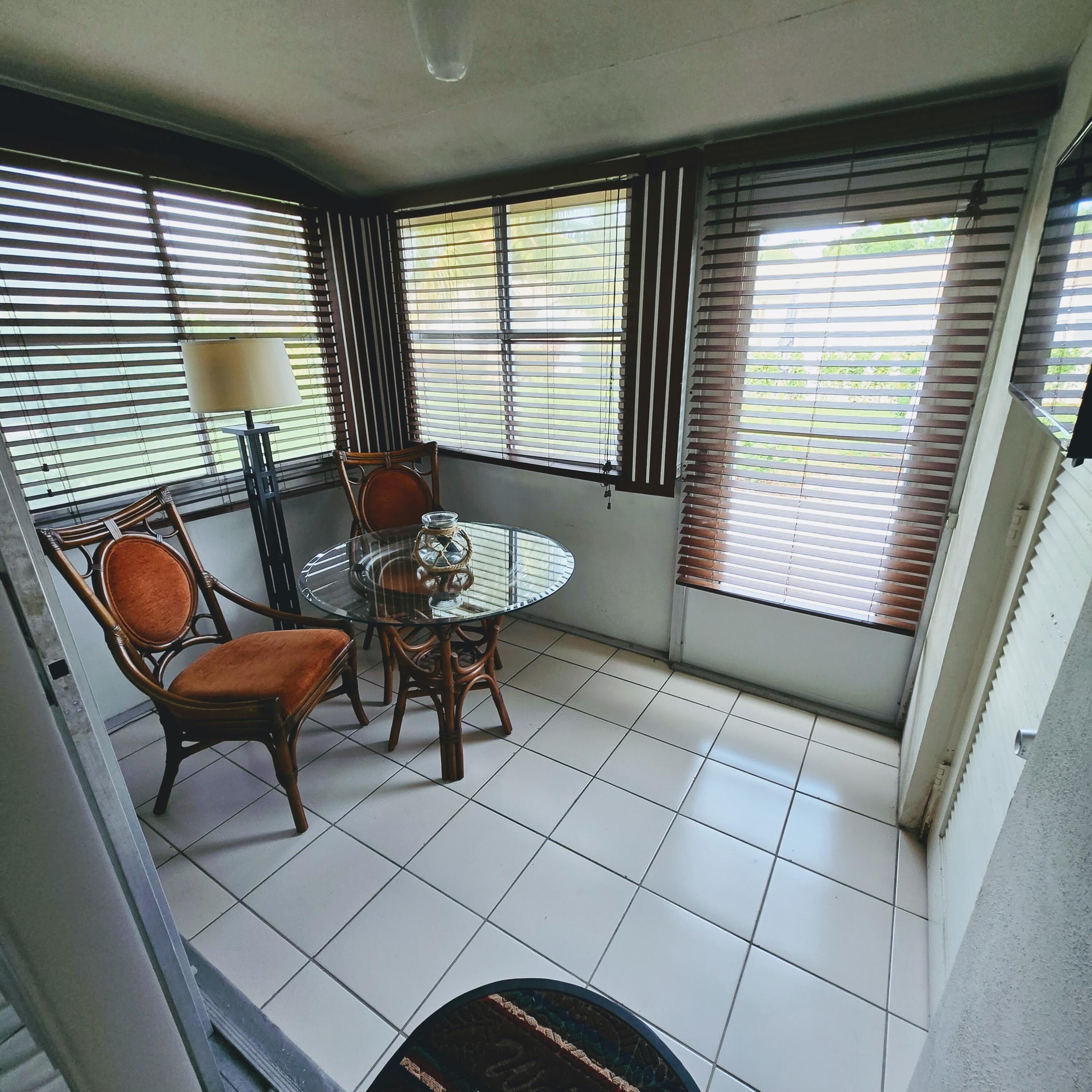 2930 Crosley Drive East, Unit C West Palm Beach, FL 33415 - Photo 10 of 21 a outdoor living space with furniture and a floor to ceiling window