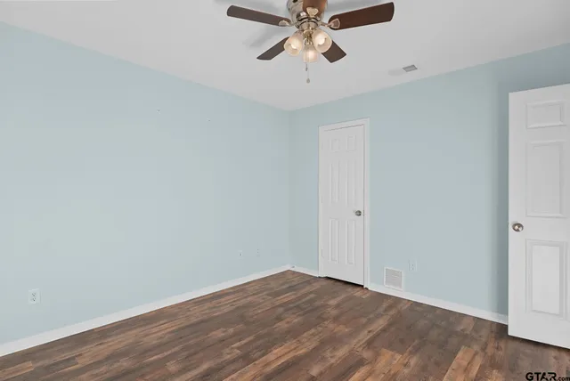 a view of a room with wooden floor and closet