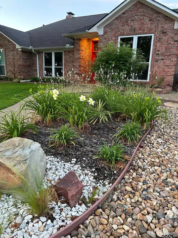 a front view of house with a garden
