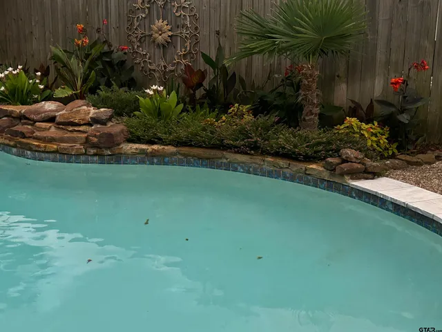 a view of backyard with garden and flowers
