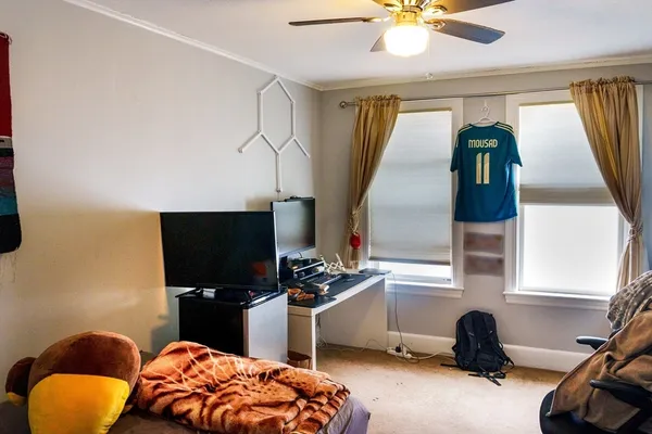 a bedroom with bed and a chandelier