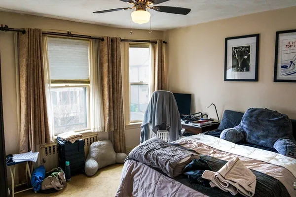 a bedroom with a bed and a couch