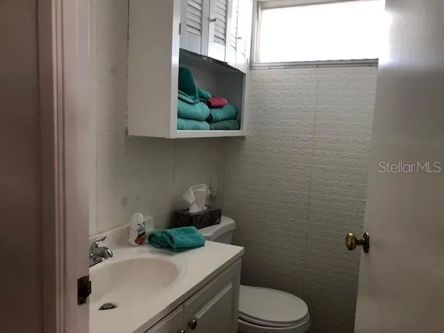 a bathroom with a sink mirror and toilet