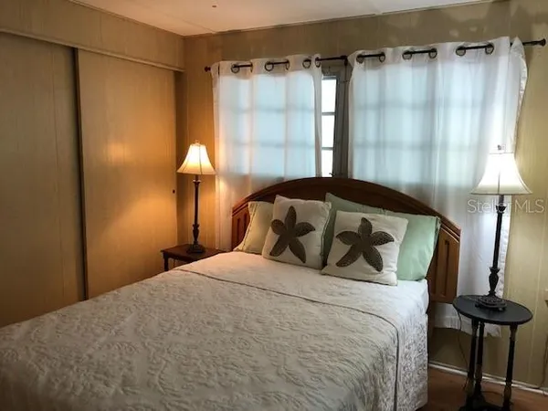 a bedroom with a bed and a lamp
