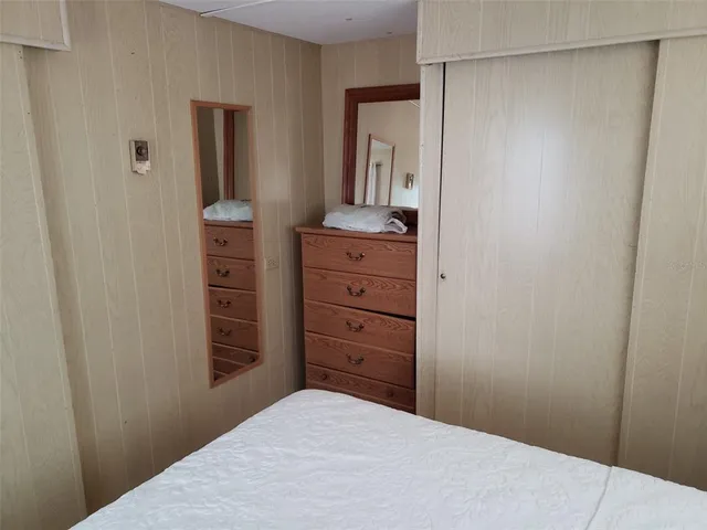 a bedroom with a dresser and a mirror