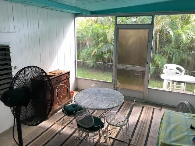 a backyard of a house with table and chairs