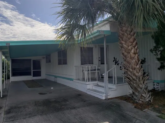 a view of a chair and table in the patio
