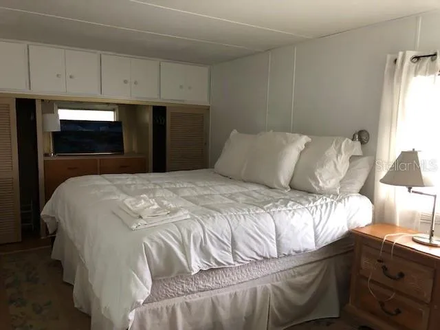 a bedroom with a bed and a mirror