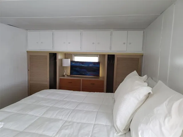 a bedroom with a bed and a television