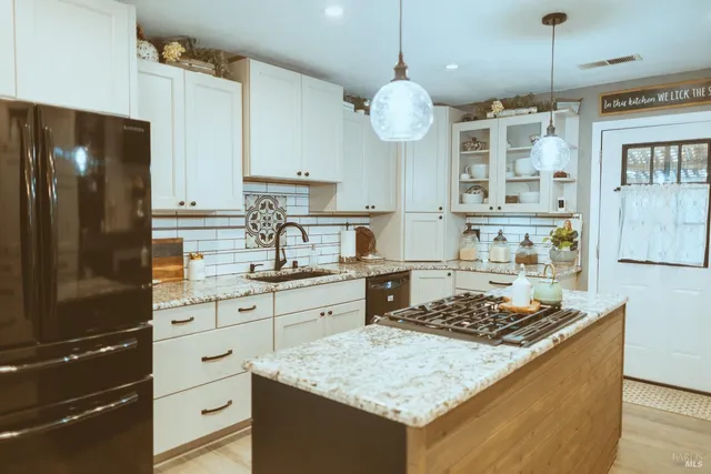 a kitchen with a sink stove and refrigerator