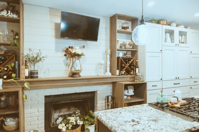 a living room with a fireplace and a flat screen tv