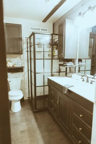 a bathroom with a toilet a sink and mirror