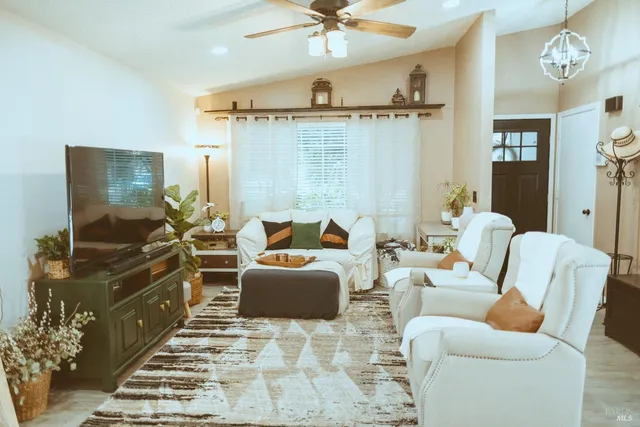 a living room with furniture a rug and a chandelier