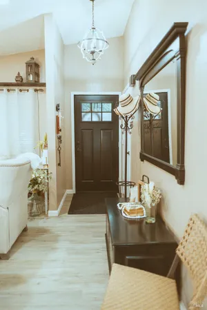 a living room with furniture a rug and a chandelier