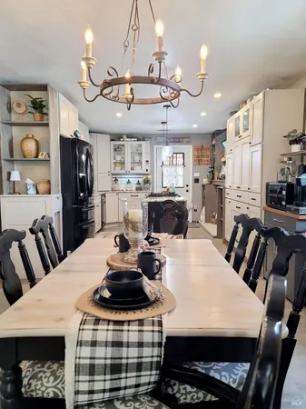 a view of a dining room with furniture and chandelier