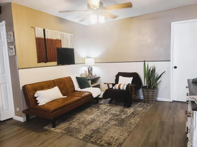 a living room with furniture and wooden floor