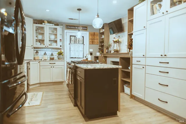 a kitchen with cabinets a sink and appliances