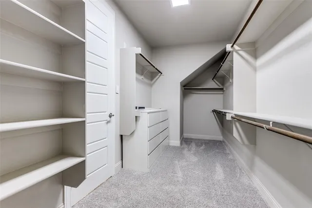 a large bed sitting in a bedroom next to a window