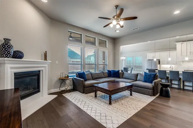 a living room with furniture a chandelier and a fireplace