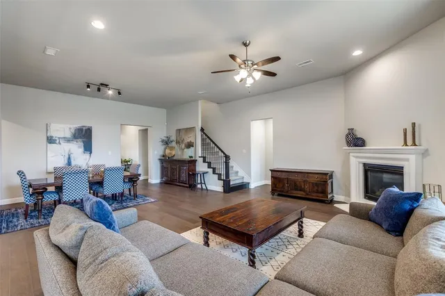 a living room with furniture a fireplace and a chandelier