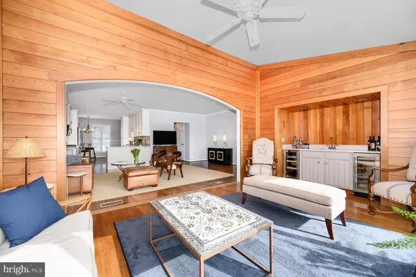 a living room with furniture a rug and white walls