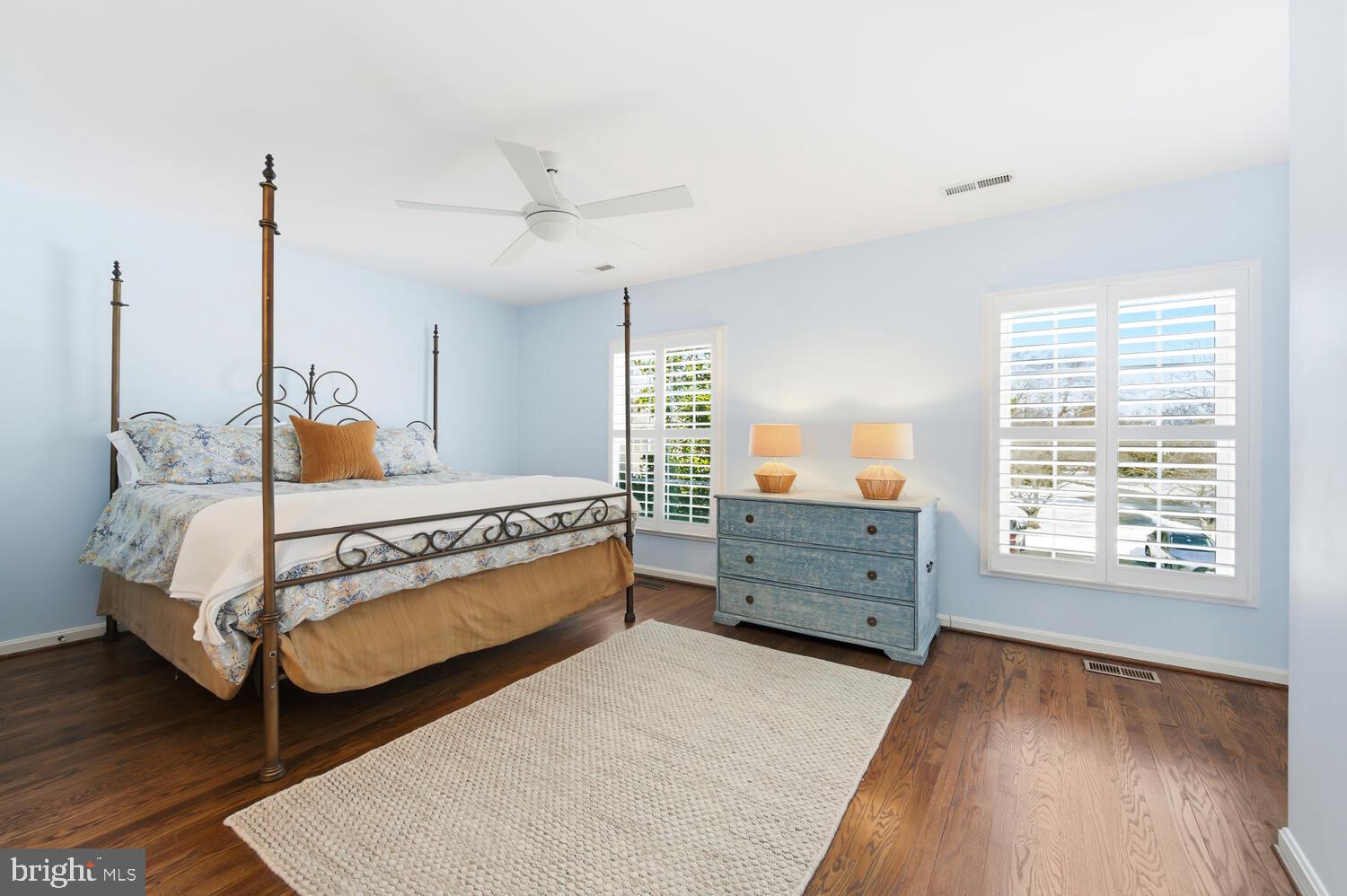 320 Perry Cabin Drive St. Michaels, MD 21663 - Photo 23 of 50 a bedroom with a bed and wooden floor
