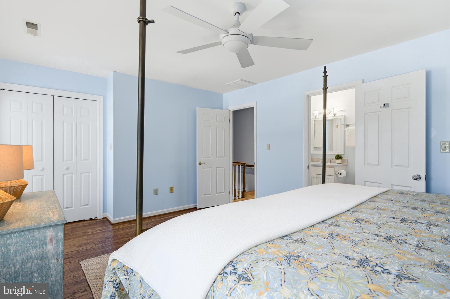 320 Perry Cabin Drive St. Michaels, MD 21663 - Photo 25 of 50 a spacious bedroom with a bed and a table fan