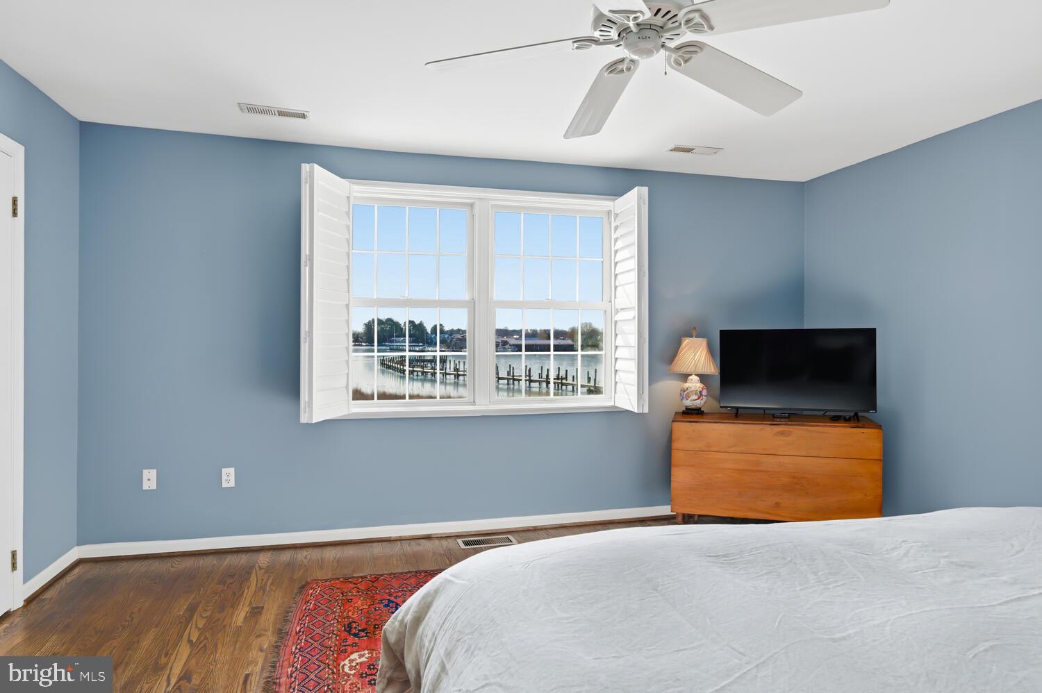 320 Perry Cabin Drive St. Michaels, MD 21663 - Photo 29 of 50 a bedroom with a bed and a chandelier