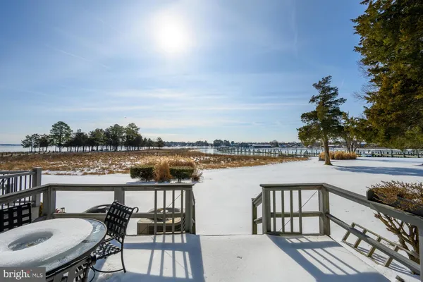 a balcony with wooden floor and lake view