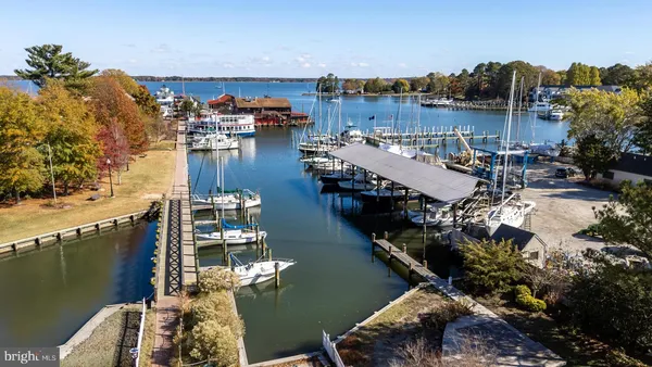 a view of a lake with a table and chairs