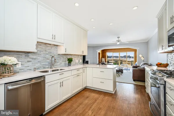 a kitchen with stainless steel appliances a stove a sink dishwasher and a refrigerator