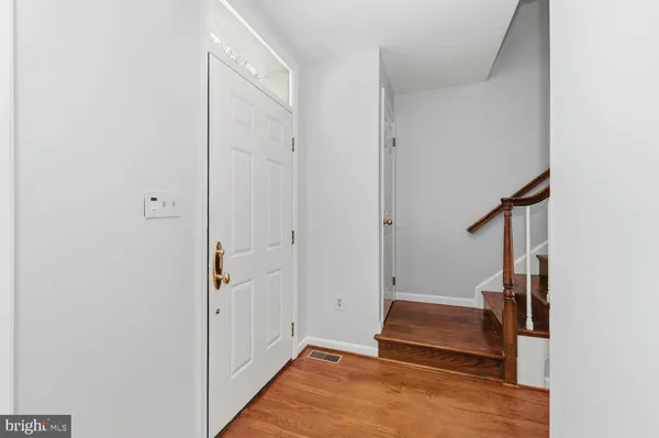 a room with white door and wooden floor