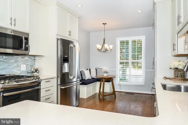 a kitchen with a refrigerator stove and sink