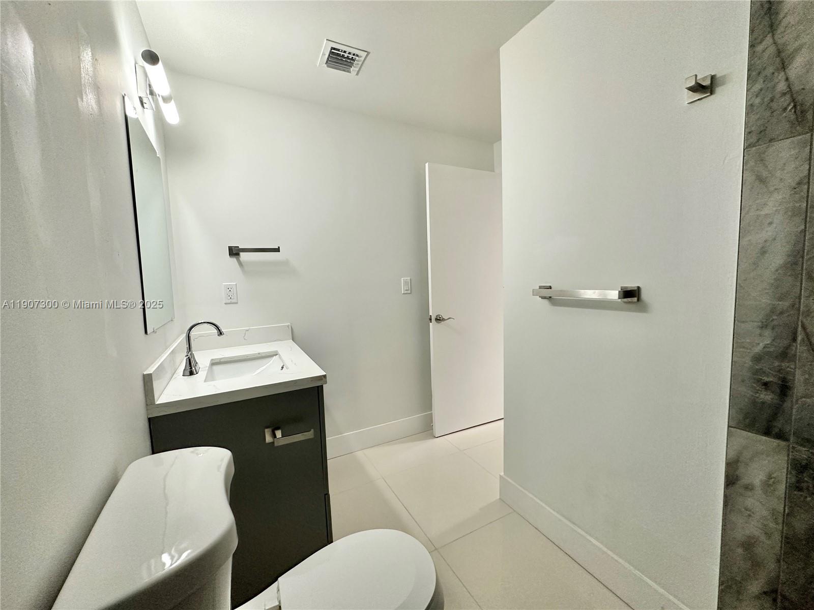 5740 Freedom Street Hollywood, FL 33021 - Photo 11 of 44 a bathroom with a toilet sink and shower