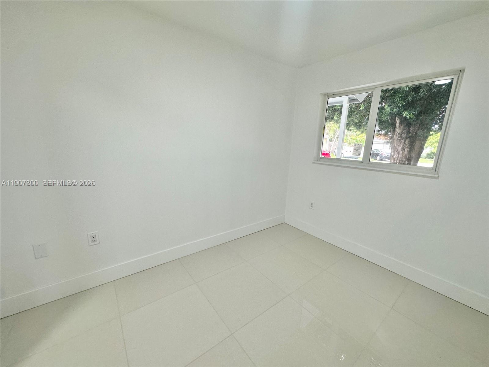 5740 Freedom Street Hollywood, FL 33021 - Photo 13 of 43 an empty room with a window