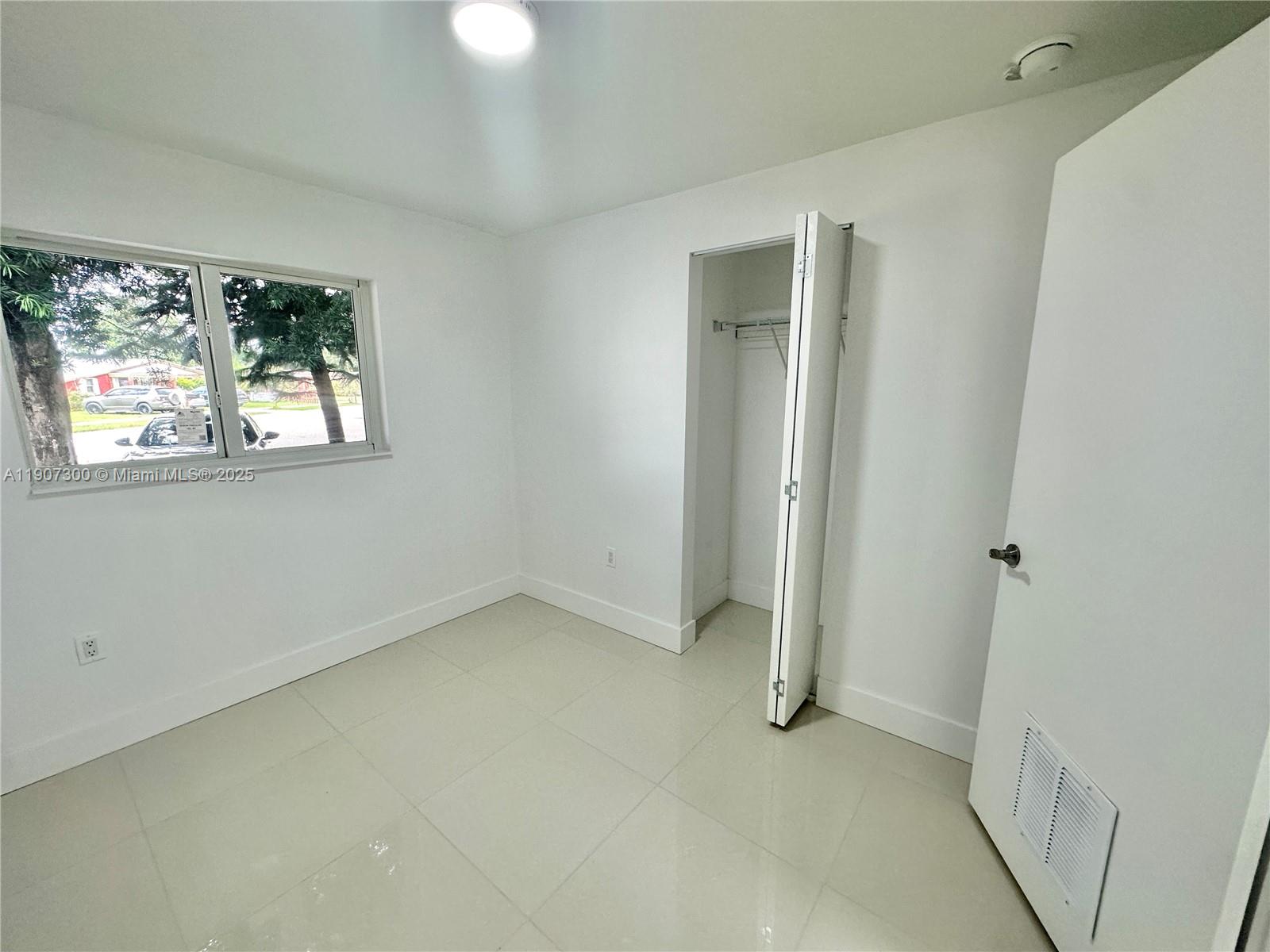 5740 Freedom Street Hollywood, FL 33021 - Photo 14 of 44 an empty room with windows and closet