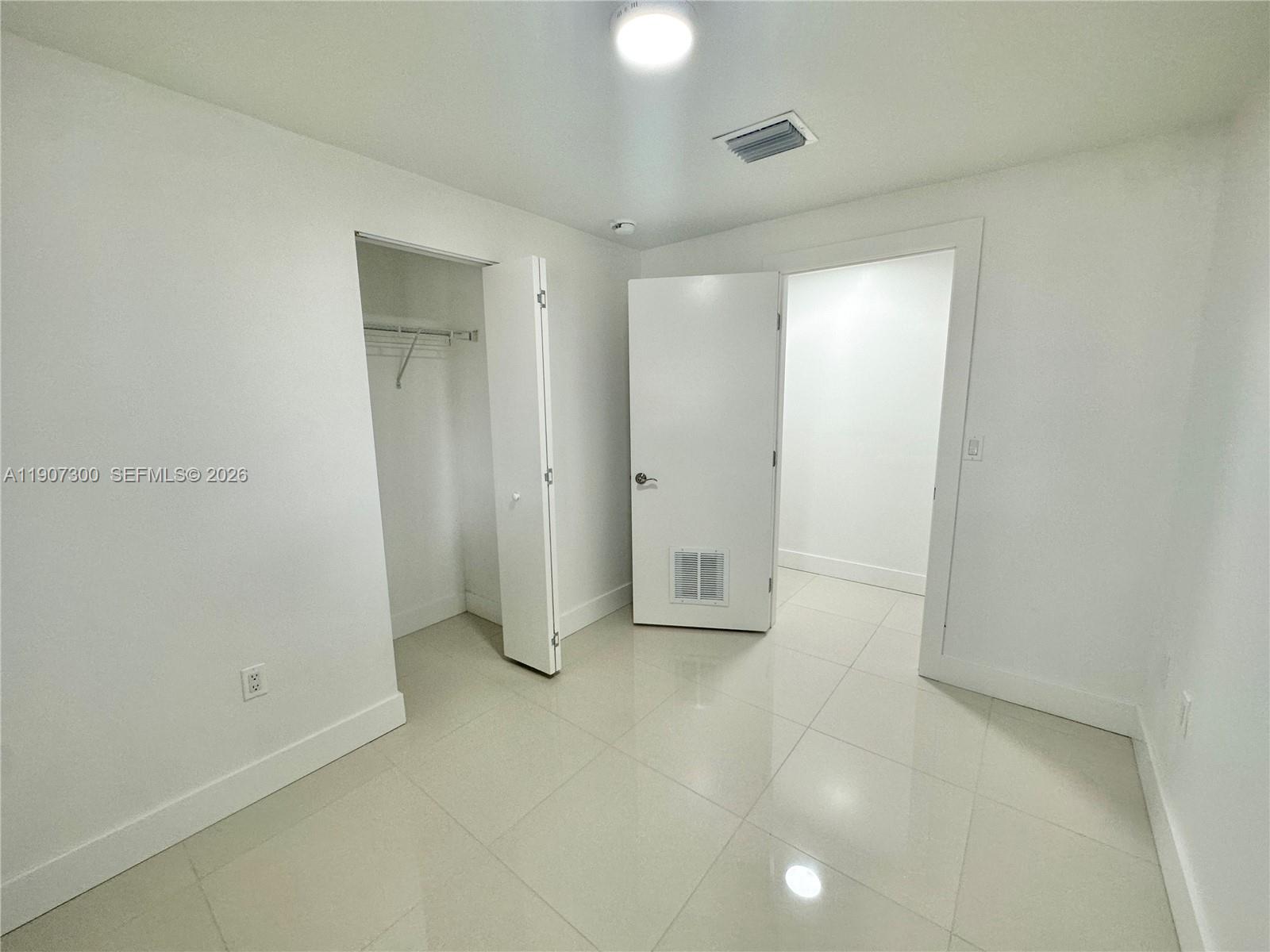 5740 Freedom Street Hollywood, FL 33021 - Photo 16 of 43 an empty room with closet and mirror