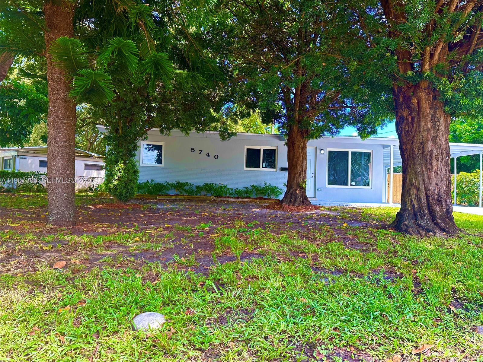 5740 Freedom Street Hollywood, FL 33021 - Photo 31 of 43 a front view of house with yard and green space