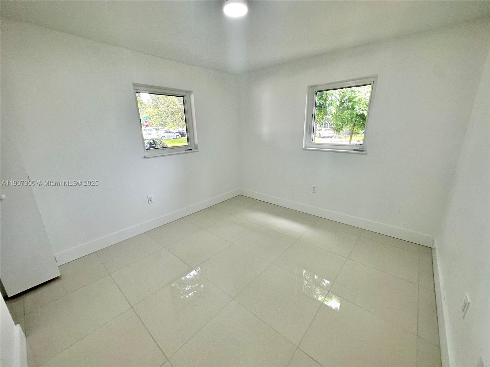 5740 Freedom Street Hollywood, FL 33021 - Photo 7 of 44 an empty room with windows