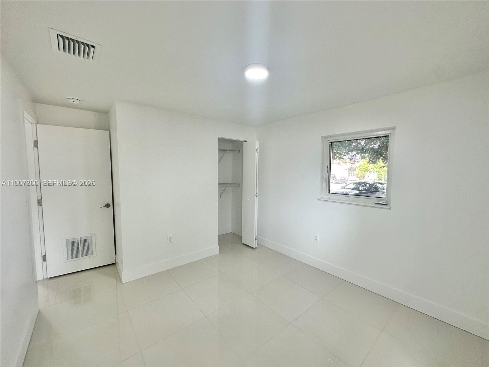 5740 Freedom Street Hollywood, FL 33021 - Photo 9 of 43 an empty room with windows