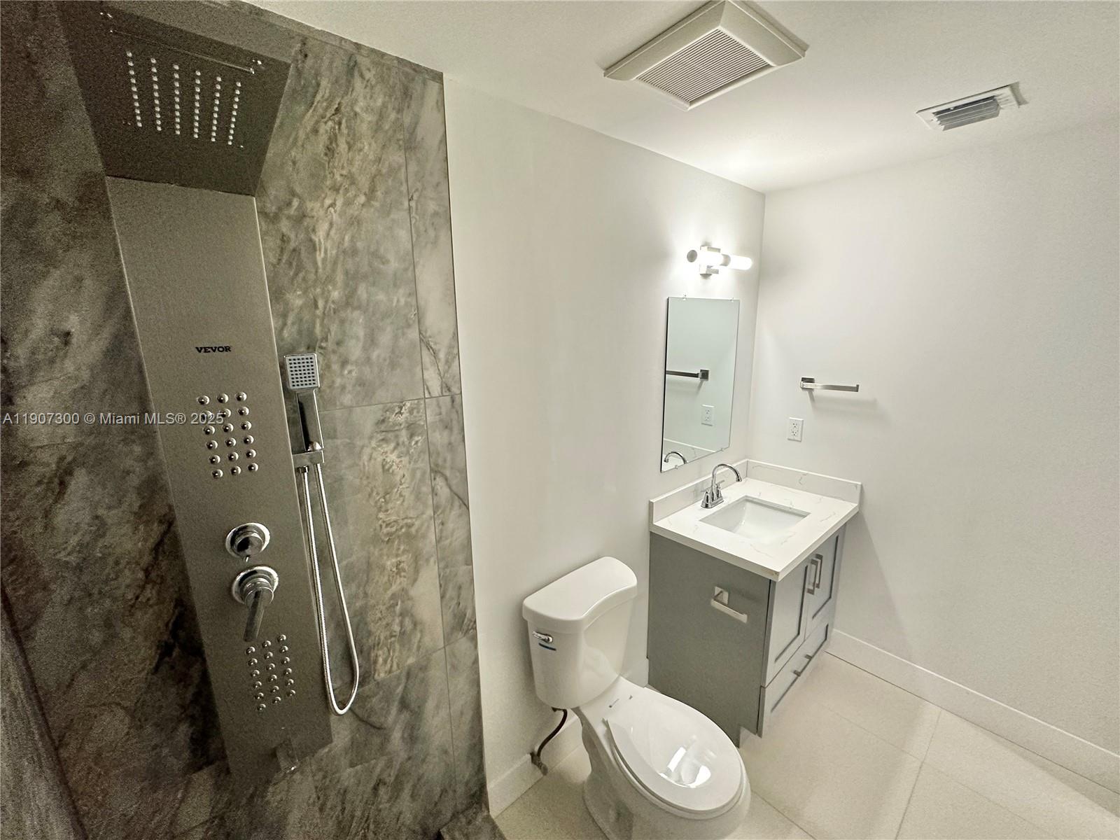 5740 Freedom Street Hollywood, FL 33021 - Photo 10 of 44 a bathroom with a toilet sink and shower