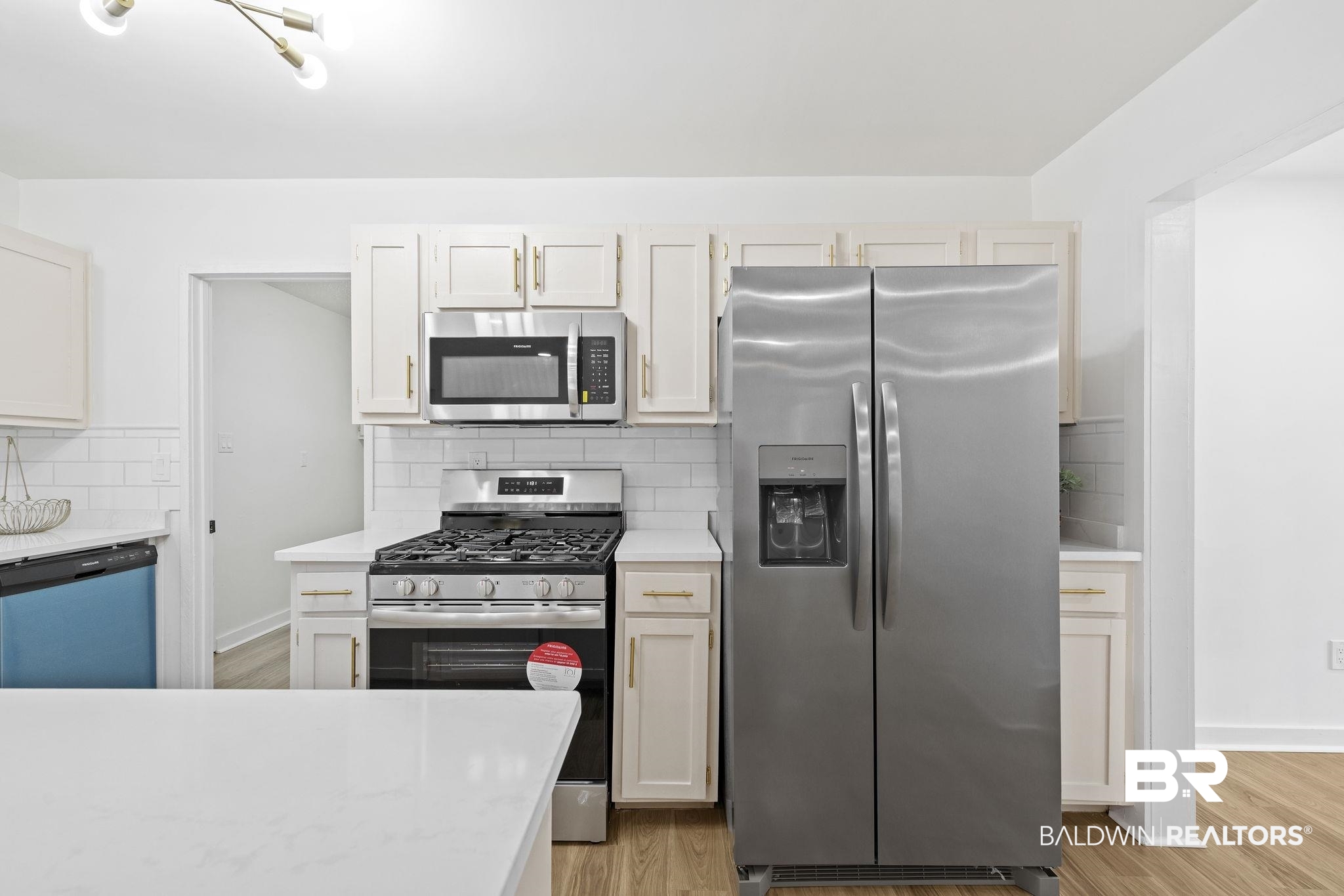 5398 Quail Run North Theodore, AL 36582 - Photo 10 of 46 Kitchen with backsplash, stainless steel appliances, and light hardwood / wood-style flooring