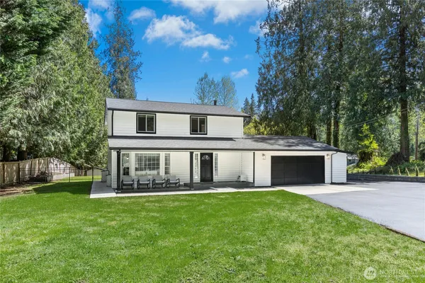 a front view of house with yard and green space