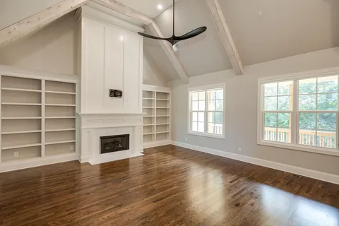 a kitchen with stainless steel appliances granite countertop a sink a stove a refrigerator and a wooden floor